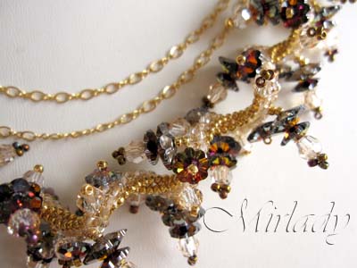 Medal winning 3 strand necklace made with Swarovski beads and gold filled findings. Classy Autumn colors